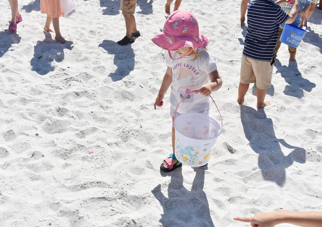This young lady had a helping hand guiding her toward a mostly buried purple Easter egg. - Joe Hendricks | Sun