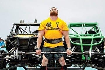 Muscle up! Strong men hit the beach