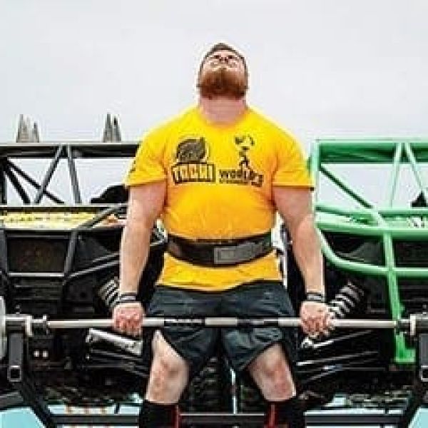 Muscle up! Strong men hit the beach