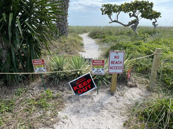 Neighbors clash over beach access path